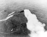 Niagara (AGP 1) burns after being attacked by Japanese aircraft east of Cape Surville, San Cristobal Islands (Solomon Islands), on 23 May 1943. PT-146 is alongside the stern (port) while<br>PT-147 moves up to the starboard side, aft. The tender sank later that day. Other boats (PT-144, PT-145, PT-148, or PT-110) maneuver to pick up other men <br> US National Archives photo 80-G-68537